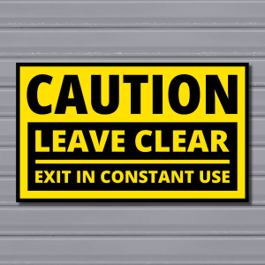 Leave Clear – Exit in Constant Use Sign (Line Divider, Black & Yellow)